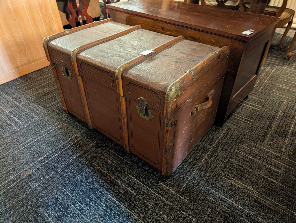 Antique Steamer Trunk / Travel Chest Antique steamer trunk featuring a brown textured exterior with decorative black line detailing, wood slat reinforcements, brass-tone corner and strap hardware, and two front latches. The interior retains its original s